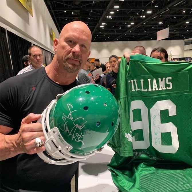 Former 6-time WWE champion and legend Stone Cold Steve Austin posted this photo when he attended the Silicon Valley Comic Con and wrote, 'Had a great time at @svcomiccon today! Met people from all over the place. Caught up w @theofficiallouferrigno and met @stevewozniakofficial. Somebody brought a North Texas State University helmet and a replica of my old jersey. Now known as University of North Texas. #meangreen #eagles'