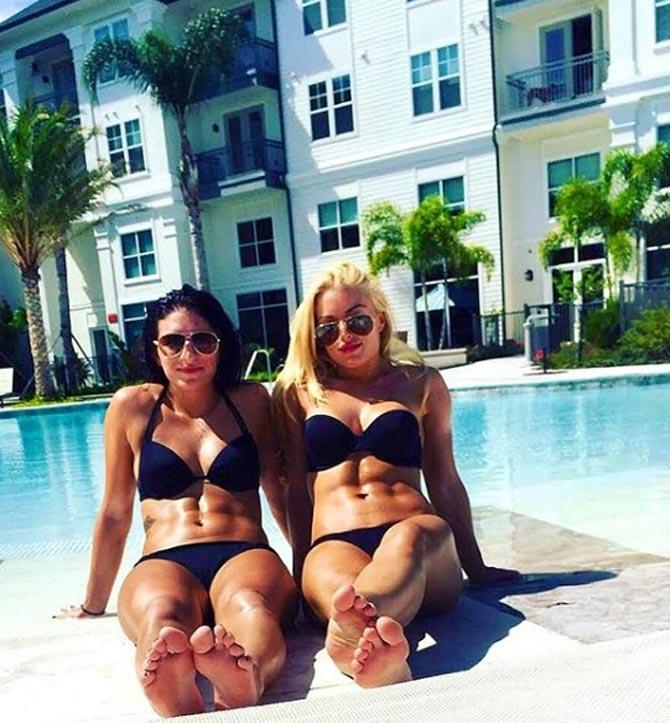 Mandy Rose posted this picture along with her tag team partner Sonya DeVille, as they were twinning in black bikinis. She captioned it: #AbsNDonuts @sonyadevillewwe #SDLIVE #FireNDesire #SorryNotSorry #BALANCE