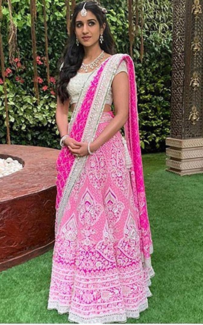 Anant Ambani's friend, Radhika Merchant looked absolutely stunning in a shocking pink chikankari ghagra by the designers. She paired it with an offwhite sequins scallops blouse and a pink sequins Jaali dupatta with crystal borders which provided for the final flourish to her ensemble.