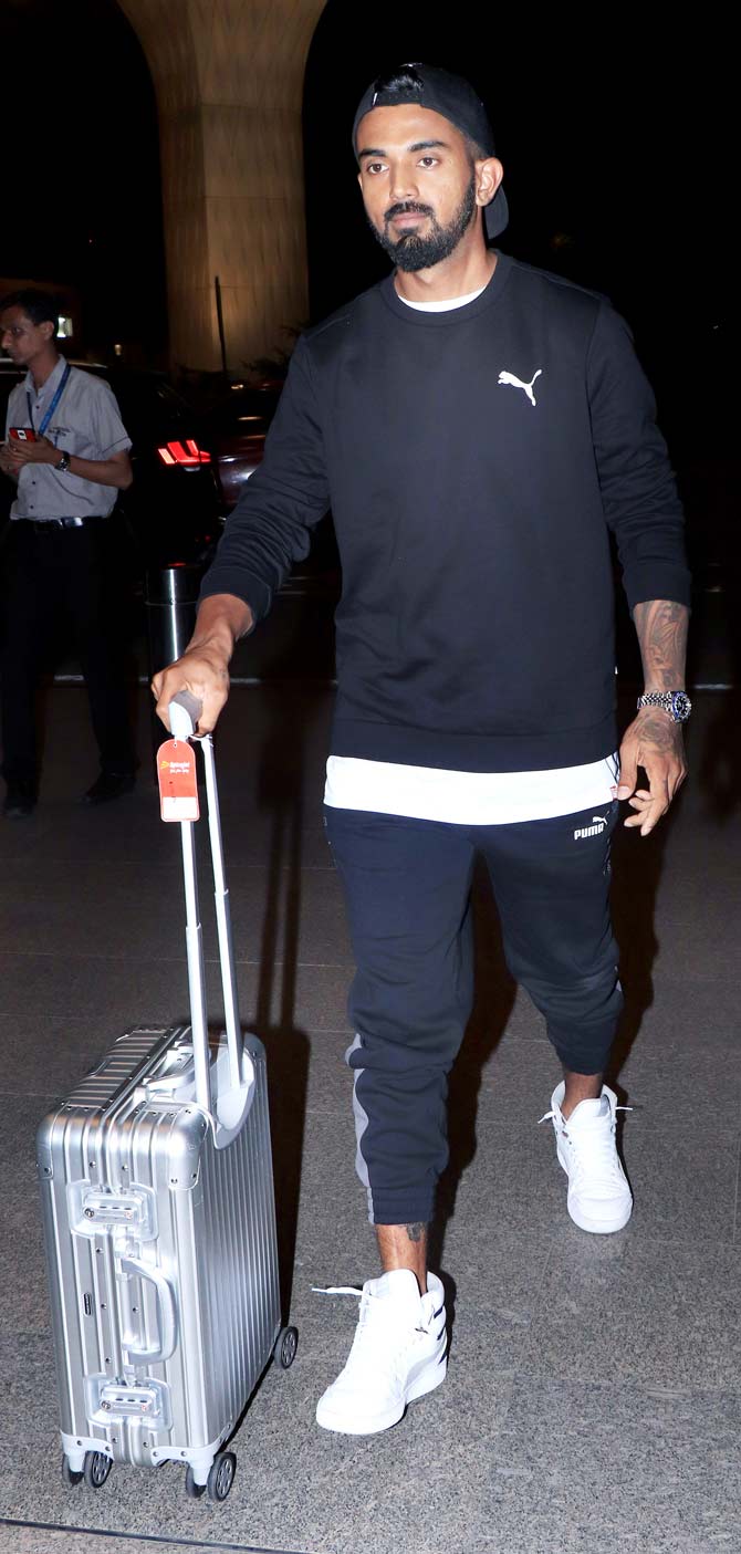 KL Rahul was seen wearing a white t-shirt with a black sweatshirt and similar coloured track pants and a cap. He sported white sneakers below