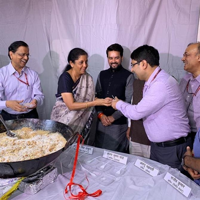 In photo: Finance Minister Nirmala Sitharaman caught in a candid mommet as she serves halwa to her colleagues during the halwa ceremony which marks the beginning of printing of budget-related documents