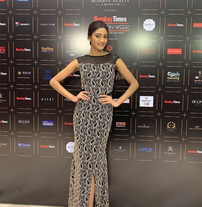 During her first time as a showstopper, Shreya wore a black printed gown with a net. With minimal makeup and no accessories, Shreya kept her look simple. 