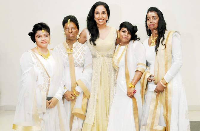 Nivedita Saboo with models showcasing her acid attack survivor collection 