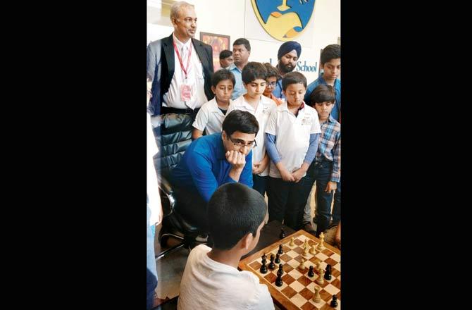 Viswanathan Anand watches a game of chess played by kids at an event in Mumbai in 2017