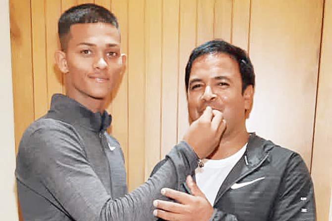 Yashasvi Jaiswal (left) celebrates by giving his coach Jwala Singh a piece of cake at the latter’s residence in Mumbai yesterday