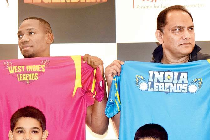 amaican sprinter Yohan Blake (left) unveils the jersey for Road Safety World T20 Series along with ex-India skipper Mohammed Azharuddin yesterday