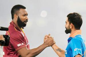 WI skipper Kieron Pollard congratulates his India counterpart Virat Kohli