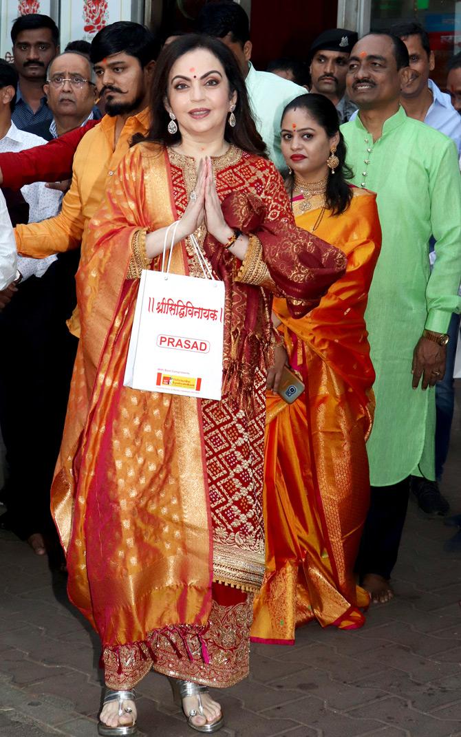 Before the grand wedding takes place, Akash Ambani plans to celebrate his bachelor's party with his friends in Switzerland between February 23 and 25.
In picture: Nita Ambani greets the media as she holds the prasad of Lord Ganesha after seeking blessings for the couple, Akash and Shloka.
