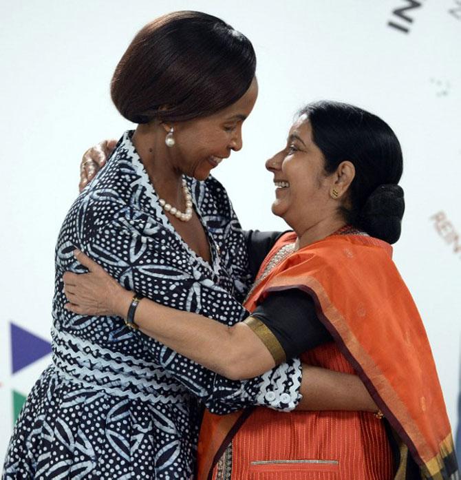 South African Foreign Minister Maite Nkoana-Mashabane (L) embraces Indian Foreign Minister Sushma Swaraj (R) during The India-Africa Summit in New Delhi on October 27, 2015. India hosted an unprecedented gathering of Africa's leaders as it ramps up the race for resources on the continent, where its rival China already has a major head start. Postponed since December over the Ebola crisis, the India-Africa Forum Summit from October 26-29 was the first under Prime Minister Narendra Modi and the biggest gathering of foreign dignitaries in India since 1983