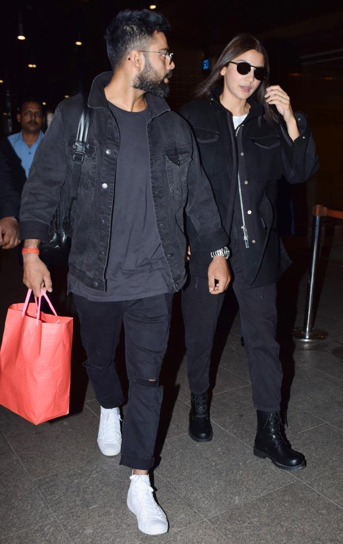 Anushka Sharma was wearing a black jacket on top of a white top, with black pants and black shoes, paired with a pair of back sunglasses.