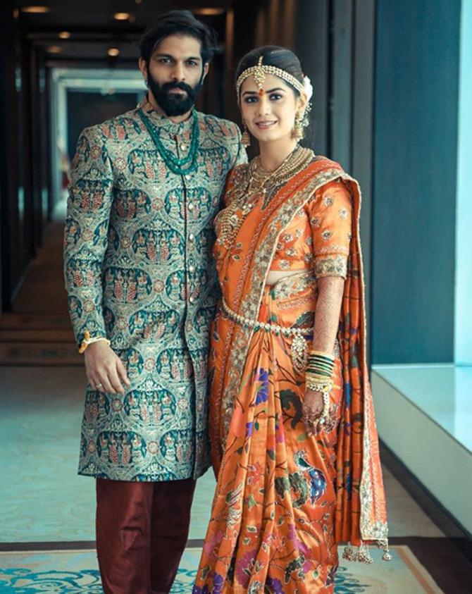Amit Thackeray and Mitali Borude's traditional Maharashtrian wedding was an intimate affair that was graced by their friends and families in Mumbai. For the wedding, Amit Thackeray was seen sporting a sherwani while his better half, Mitali Borude donned a stunning orange Paithani saree and complimented her look with a lot of traditional Maharashtrian jewellery. Pic/Instagram Picture It Photo Company