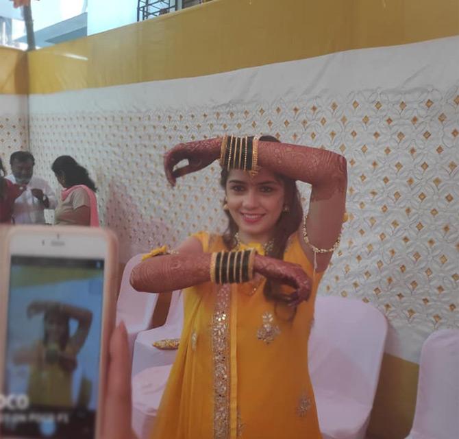 In photo: Amit Thackeray's wife (then fiance) Mitali Borude is seen posing with her choodiyan (bangles) just before the start of the Haldi ceremony. Pic/Facebook Priyanka Madhav Borude