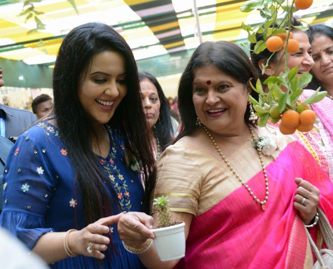 Amruta Fadnavis shares a laugh as Harsha Hinduja shows her the variety of bonsai plants at the exhibition in Vile Parle.