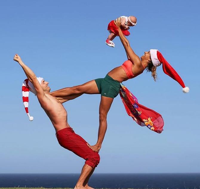 In the pic: Honza and Claudine add Christmas twist to their regular Acroyoga practise with baby Sophie.