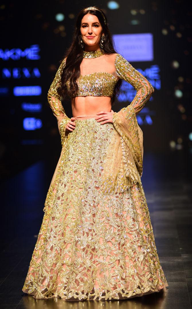 Isabelle Kaif, Katrina Kaif's sister, who is all set to make her Bollywood debut opposite Sooraj Pancholi with Time To Dance, was seen in a golden and nude coloured ensemble at the fashion show. 