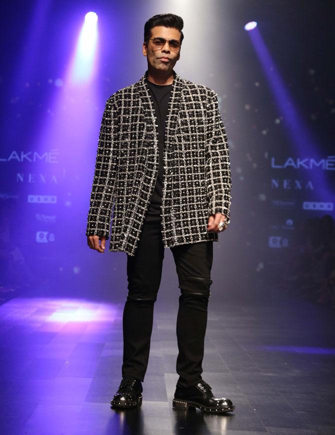 Karan Johar looked dapper in an all-black ensemble, paired with a monochrome checkered coat at the day 5 of Lakme Fashion Week Summer/Resort 2019.