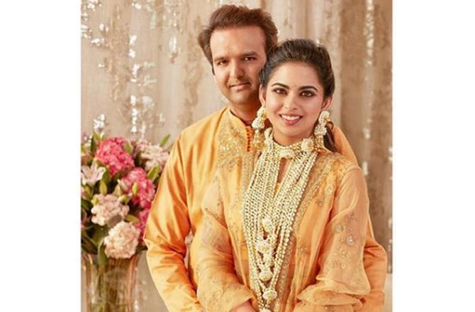 Isha Ambani and Anand Piramal got engaged in May 2018 and the pre-wedding ritual, God Dhana, was organised at the Ambani residence - Antilla. During the month of September, the Ambani family hosted a three-day extravaganza in the picturesque Lake Como in Italy, which was attended by a list of Bollywood celebs, among othersIn picture: Isha Ambani poses with husband Anand Piramal in striking color-coordinated yellow outfits.