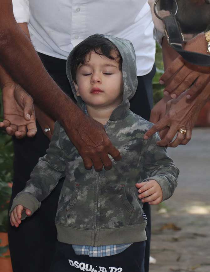Bollywood's favourite star kid Taimur Ali Khan was spotting braving the chilly weather by wearing a hoodie in Bandra, Mumbai. Little Tim (as he is affectionately called by his father) is fully aware of his best camera angles. He calls out to the paparazzi who adore him and always ensure his comfort before clicking. All pictures/Yogen Shah