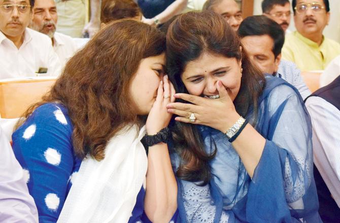 BJP MP Poonam Mahjan and State Minister of Rural Development, Women and Child Welfare Pankaja Munde share a joke at the event