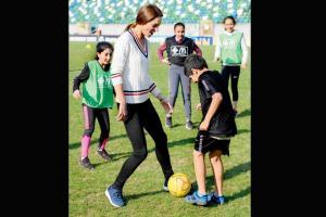 Duchess of Cambridge Catherine plays football with children