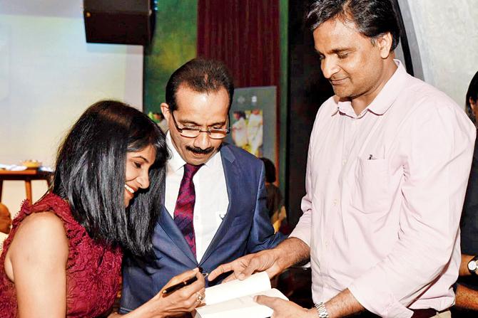Author Prajwal Hegde signs a copy of What