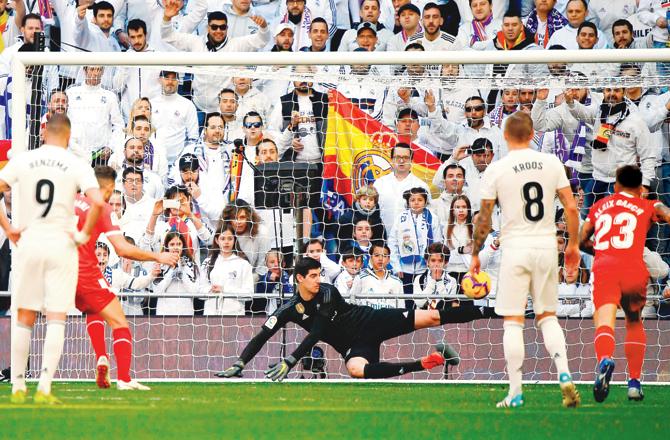Girona striker Cristhian Stuani (right) beats Real Madrid goalkeeper Thibaut Courtois to score off a penalty kick