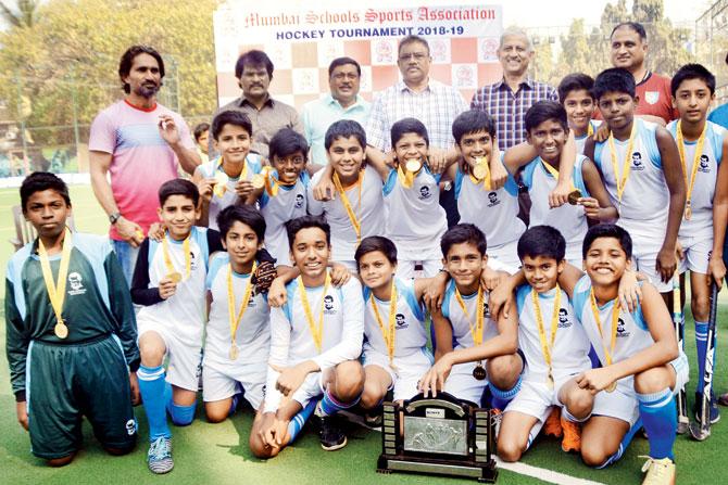 The victorious Don Bosco boys team with the MSSA hockey U-14 Div I trophy at the St Stanislaus ground, Bandra on Friday