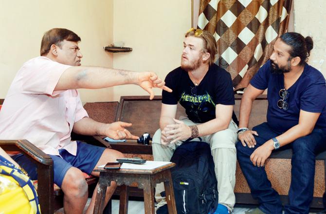 Dr Kasun Ubayasiri (in blue tee) and Griffith University students speaking to separate families in Dharavi during their month-long stay in the city. Pics/Sneha Kharabe