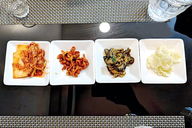 (From left) Sides include kimchi, dried chilli radish, pickled eggplant and cucumber. Pics/Datta Kumbhar