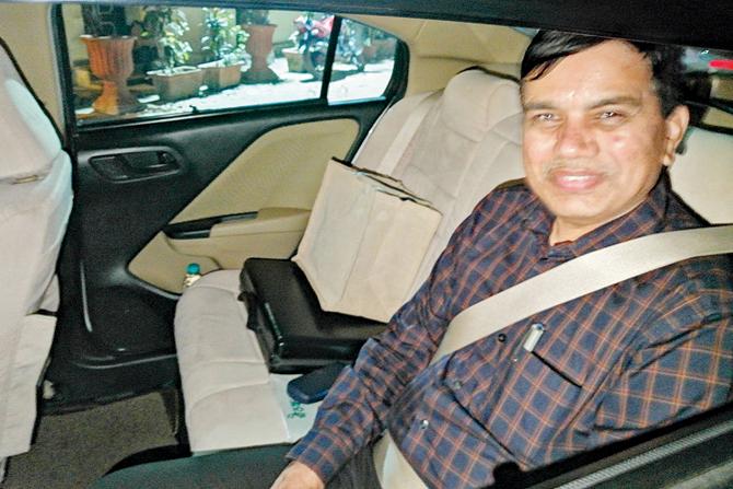 Transport Commissioner Shekhar Channe wears a seat belt while on the rear seat