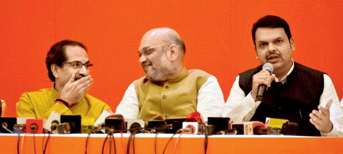 Shiv Sena chief Uddhav Thackeray, BJP president Amit Shah and CM Devendra Fadanvis are all smiles while addressing the media on their pre-poll alliance at a Worli hotel on Monday. Pics/Ashish Raje