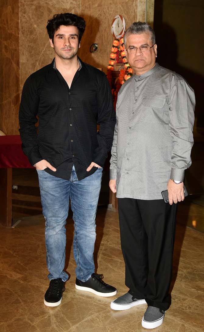 Girish Taurani with father Kumar S. Taurani pose for the photographers at Ramesh Taurani's residence.
