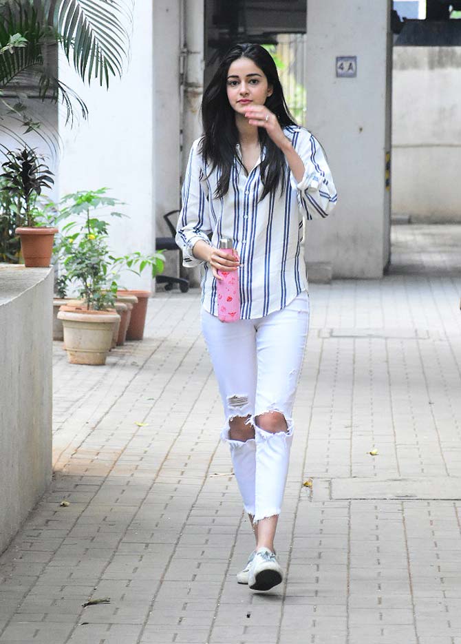 Ananya Panday was spotted at her casual best at Dinesh Vijan's office in Bandra, Mumbai. The actress opted for a striped shirt, paired with distressed denim and sneakers. 