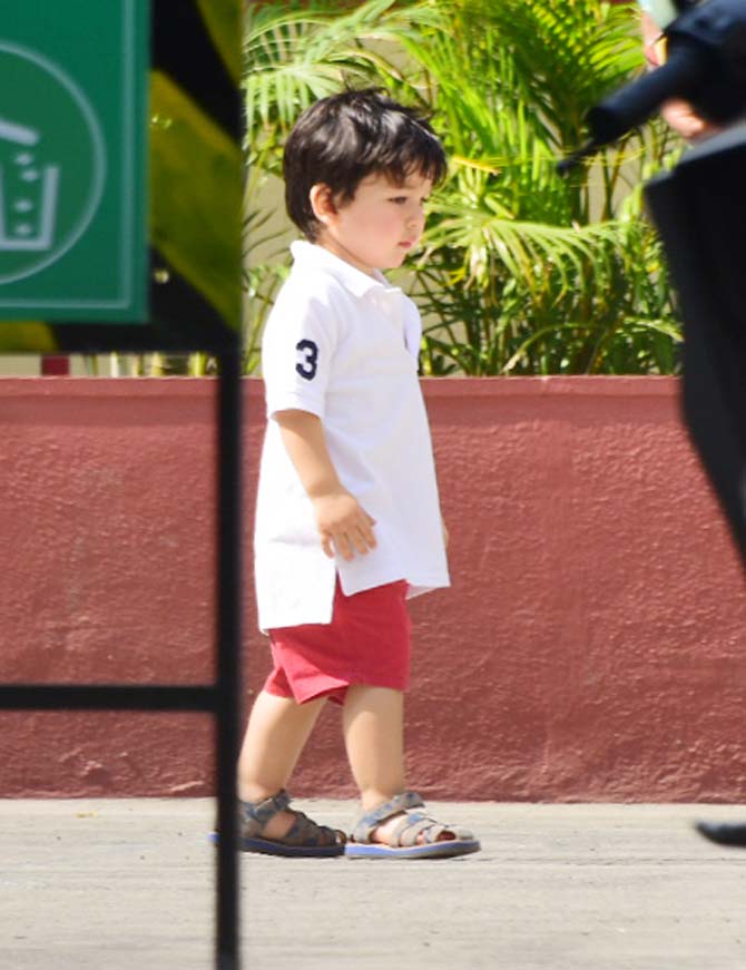 Taimur Ali Khan was spotted playing football with daddy Saif Ali Khan at a playground in Bandra, Mumbai. The tiny tot was sporting a white polo-neck t-shirt, paired with red shorts and baby sandals. All pictures/Yogen Shah