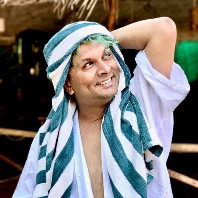 Harish Iyer is very fond of trying different hair colours and styles to express his vibrant personality. 
In pic: Harish gets creative with his swimming pool towel flaunting his green hair. He is known to be a colourful personality in and out.