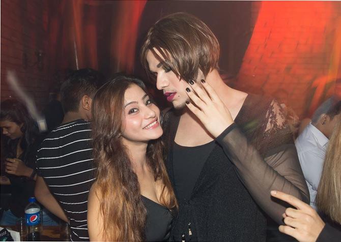 Faizal in his new hairstyle, Victorian bob posing with a friend in his black outfit and matching nail paint. He can definitely slay any look without a doubt.