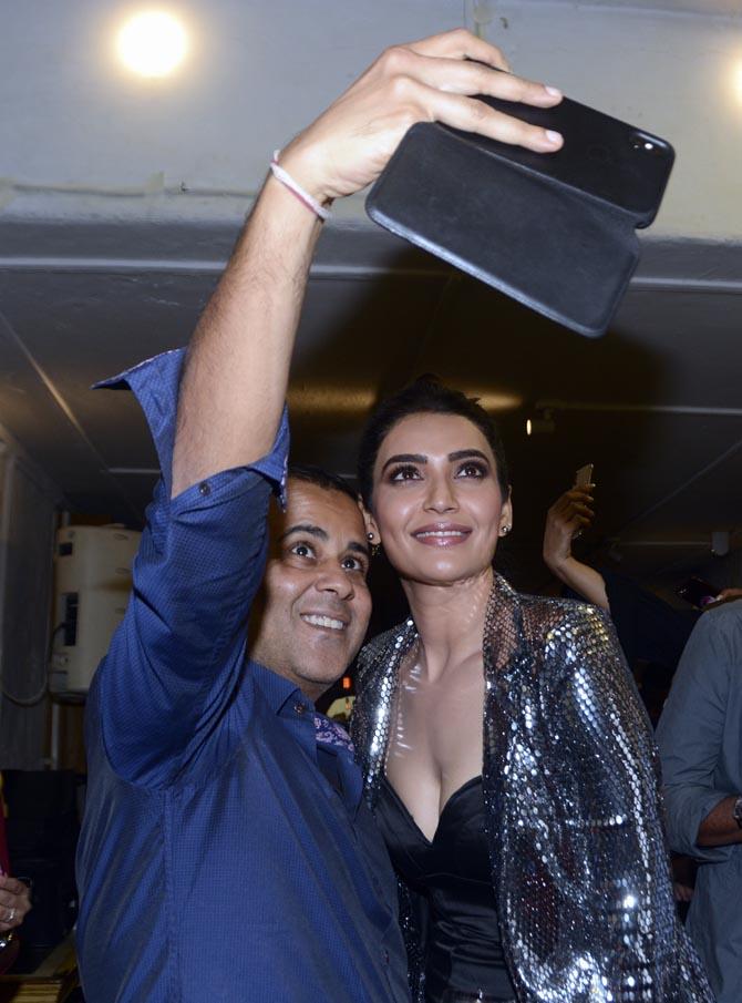 Chetan Bhagat and Karishma Tanna clicked while the duo was busy taking a selfie at the launch event of Dabboo Ratnani's Calendar 2019.