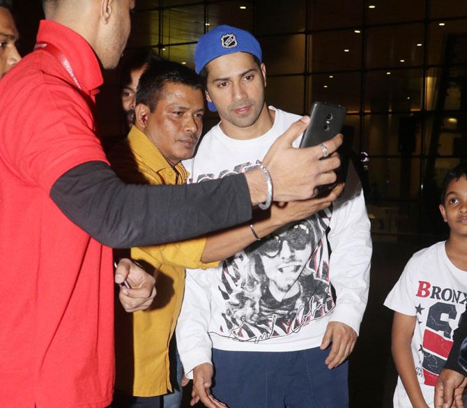 Recently, Varun Dhawan and Alia Bhatt wrapped up their schedule for the period drama Kalank, and the duo has shared a pretty picture on their social media handle. Kalank is an upcoming period drama film directed by Abhishek Varman and produced by Karan Johar, Sajid Nadiadwala and Fox Star Studios. It stars Madhuri Dixit, Sonakshi Sinha, Alia Bhatt, Varun Dhawan, Kunal Kemmu, Aditya Roy Kapur and Sanjay Dutt in lead roles.
In picture: Varun Dhawan obliges for a selfie with fans.