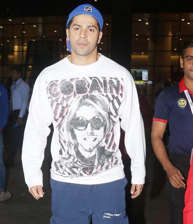 Varun Dhawan was also spotted at the Mumbai airport. Varun sported a casual look in a white printed tee, grey track pants and blue cap.