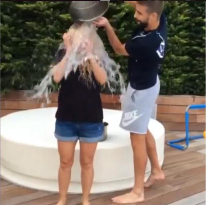 Gerard Pique seen here pouring ice water on Shakira while taking the Ice Bucket Challenge.
