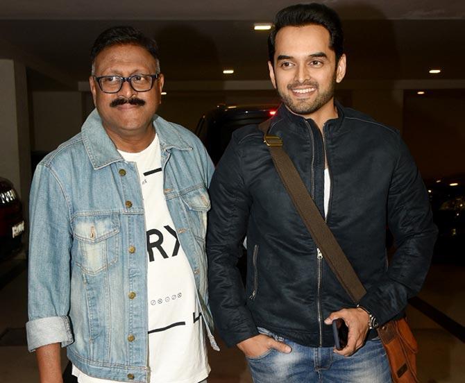 Vijay Patkar and Saurabh Ghokale pose for the photographers at Karan Johar's residence.