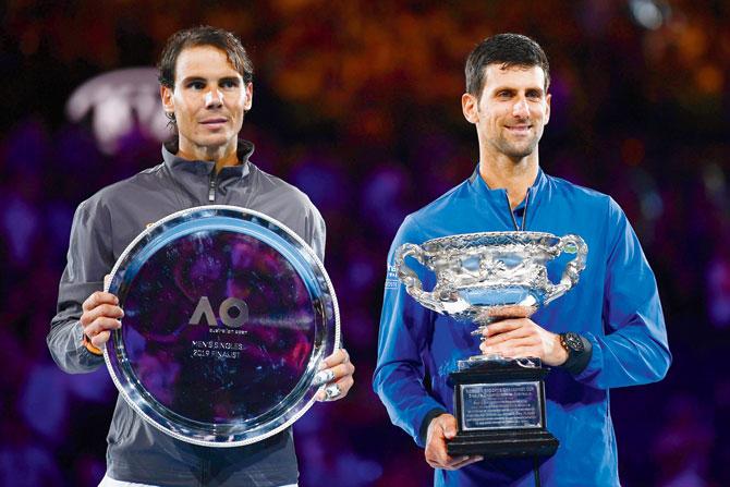 Djokovic and Nadal with their respective trophies. Pic/Getty Images
