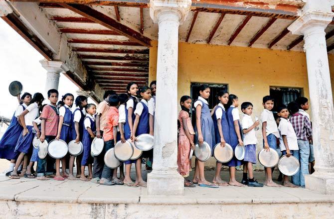 Students may soon be denied mid-day meals and scholarships because of the new order. Representation pic/AFP