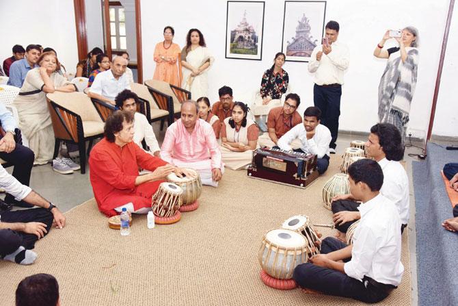 Zakir Hussain in a session with the students at the Victoria Memorial School for the Blind, as Mala Goenka (extreme right) captures the moment