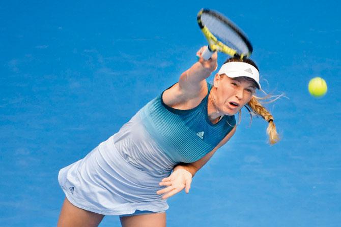 Caroline Wozniacki serves against Johanna Larsson in Melbourne yesterday. Pics/AFP