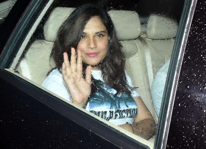 Richa Chadha waves at the photographers as she arrived for the special screening of Super 30 in Andheri.
