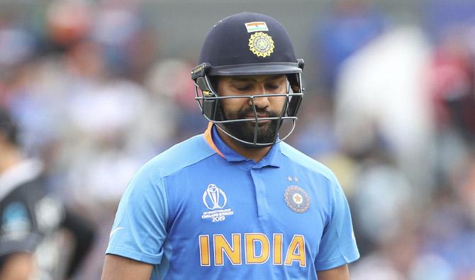 India's Rohit Sharma reacts as he leaves the field after being dismissed by New Zealand's Matt Henry during the Cricket World Cup semi-final match between India and New Zealand at Old Trafford in Manchester, England