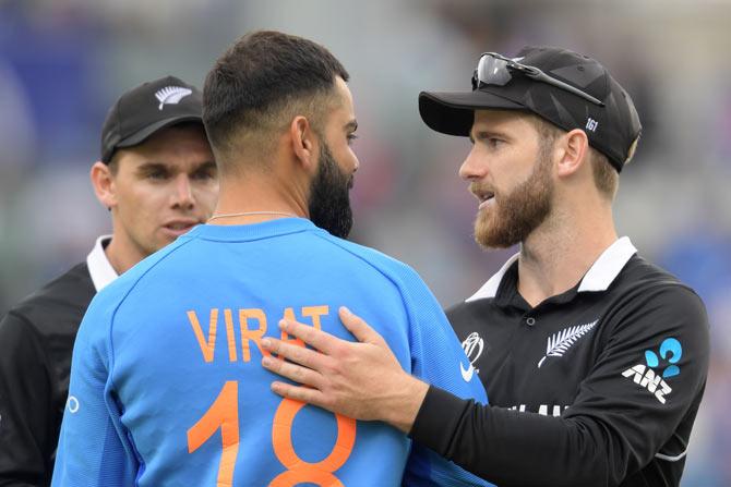 New Zealand's captain Kane Williamson greets India's captain Virat Kohli at the end of play during the 2019 Cricket World Cup first semi-final between New Zealand and India at Old Trafford in Manchester, northwest England