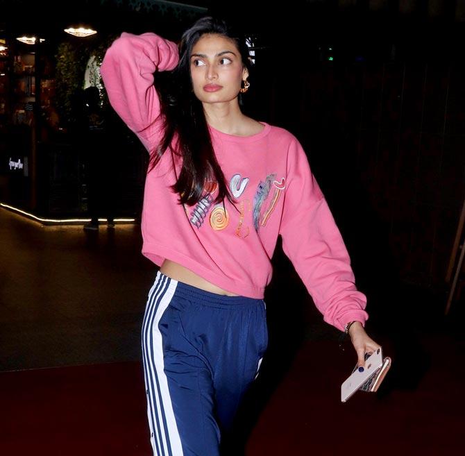 Athiya Shetty sported a pink tee and blue track pants as she was spotted at the Mumbai airport.