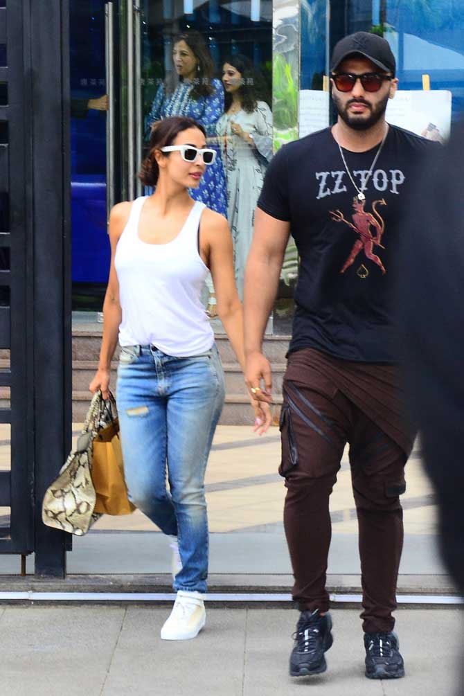 Malaika Arora and Arjun Kapoor were spotted on a lunch outing at a popular restaurant in Bandra, Mumbai. The actress was seen wearing a white t-back top, paired with basic denim and sneakers for the outing. All pictures/Yogen Shah